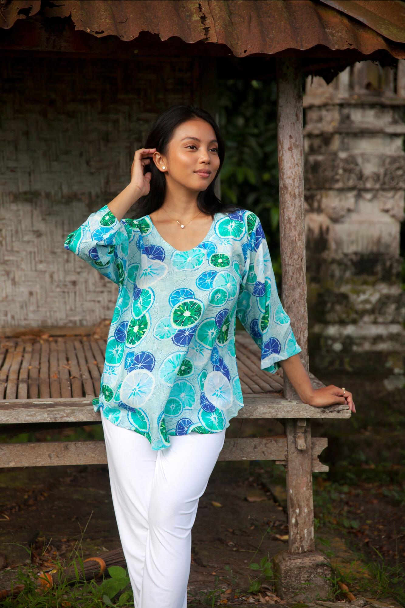 Lady in bluse with digitally printed turquoise blue motif . The blouse is in 100% voile viscose.