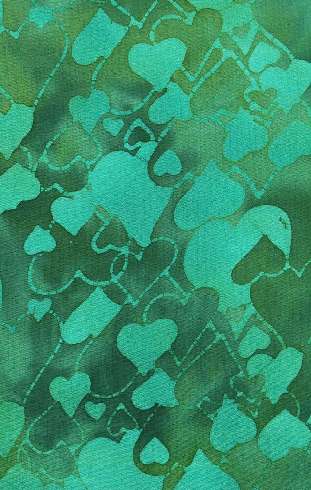 Fabric with a green heart batik stamp