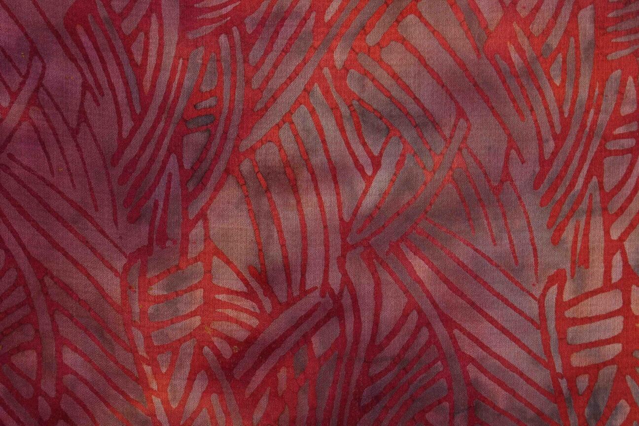 Fabric in red nuances after the wax has been boiled off the fabric. This is the final result. The lines which have been covered with wax are now prominent in a stronger red color than the rest of the fabric